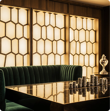 Sleek contemporary casino design with dramatic color lighting and exclusive lounge area ambiance